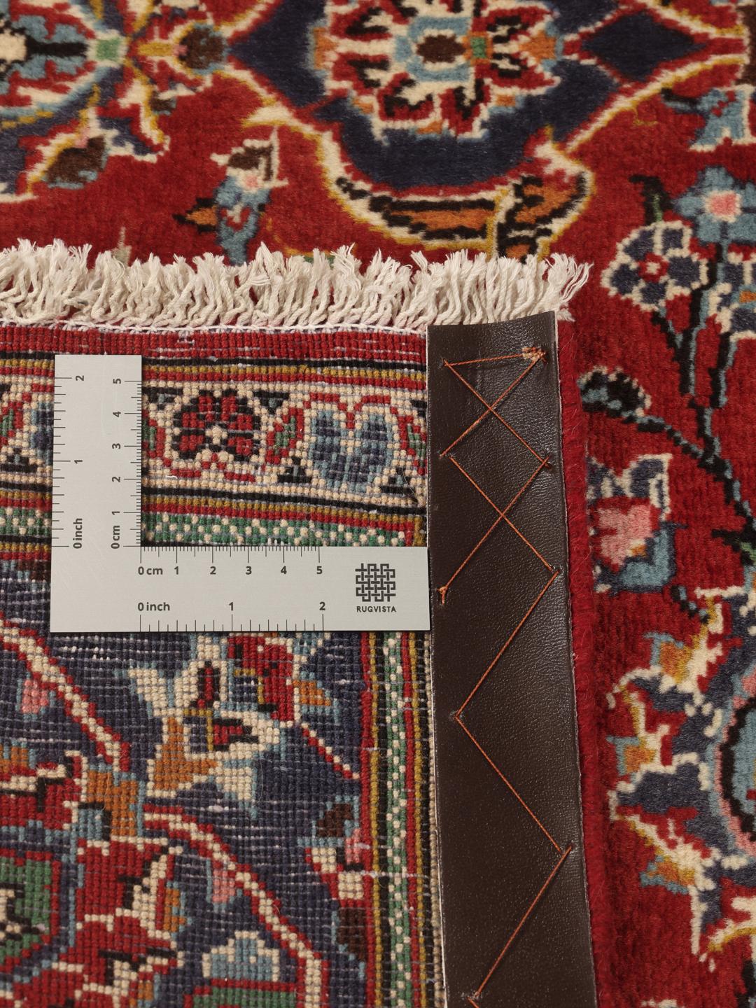 Hand-knotted Keshan rug from the Middle East in shades of red and blue.