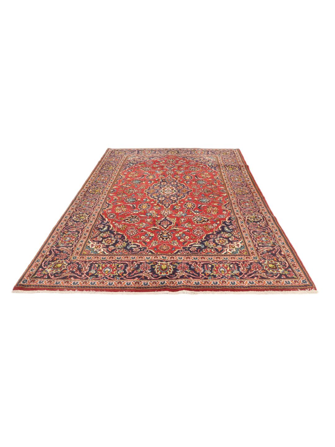 A hand-knotted Keshan rug in red and blue tones from the Middle East.