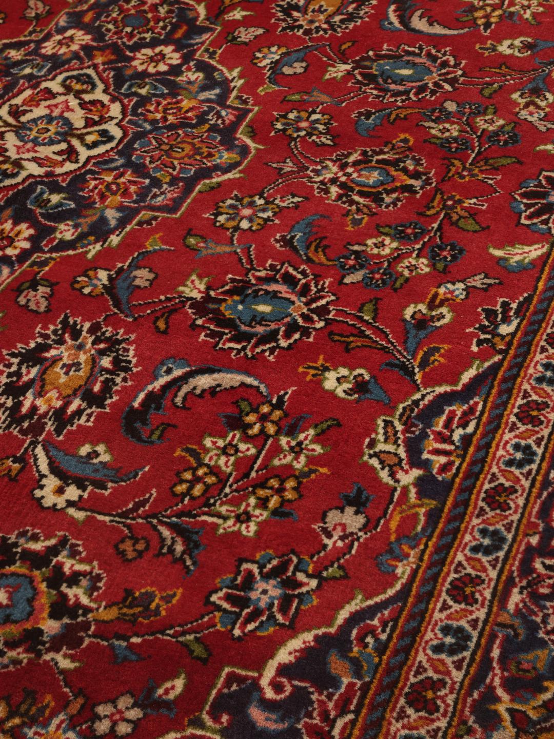 A hand-knotted Keshan rug in red and blue tones from the Middle East.