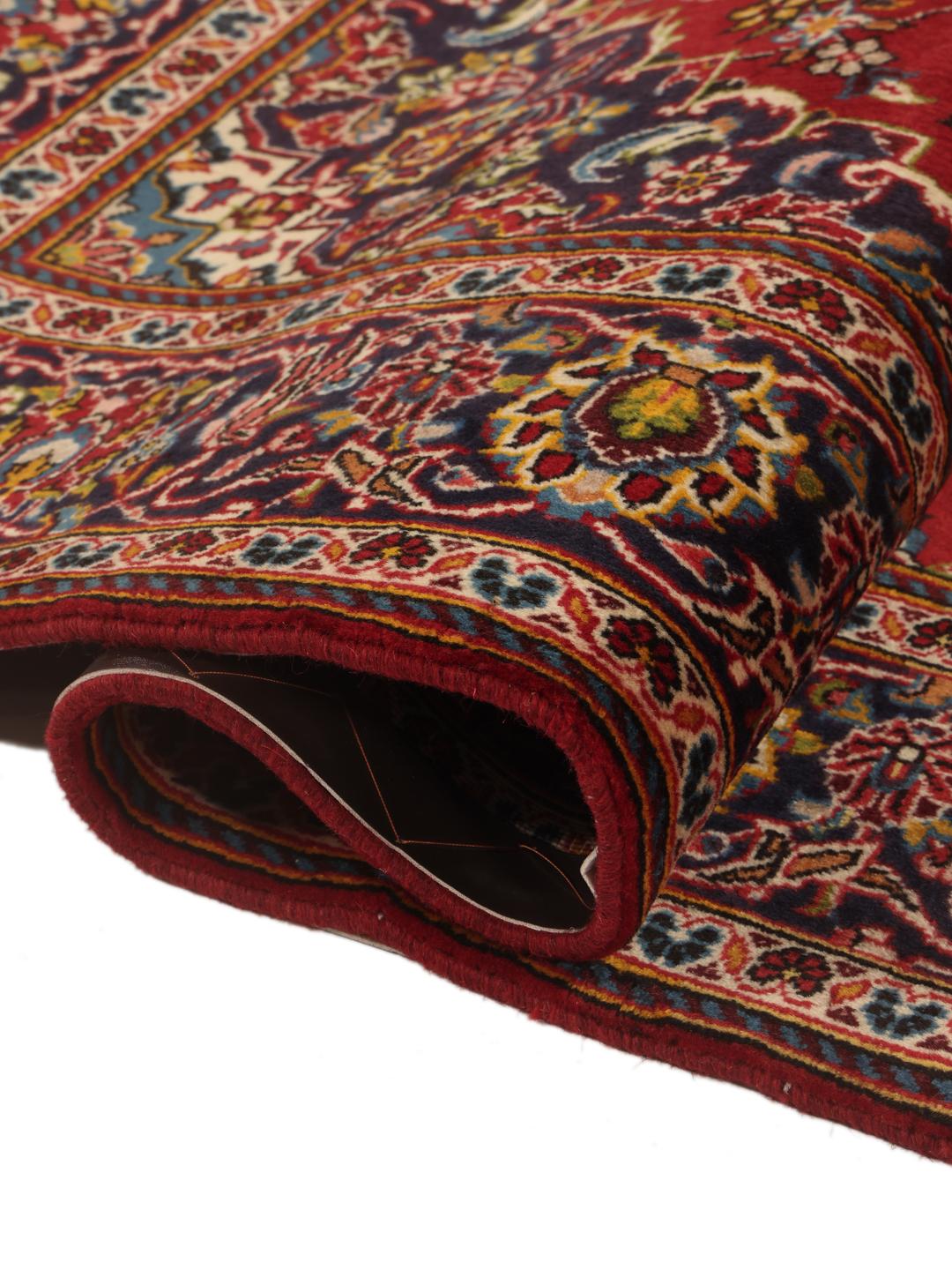 A hand-knotted Keshan rug in red and blue tones from the Middle East.
