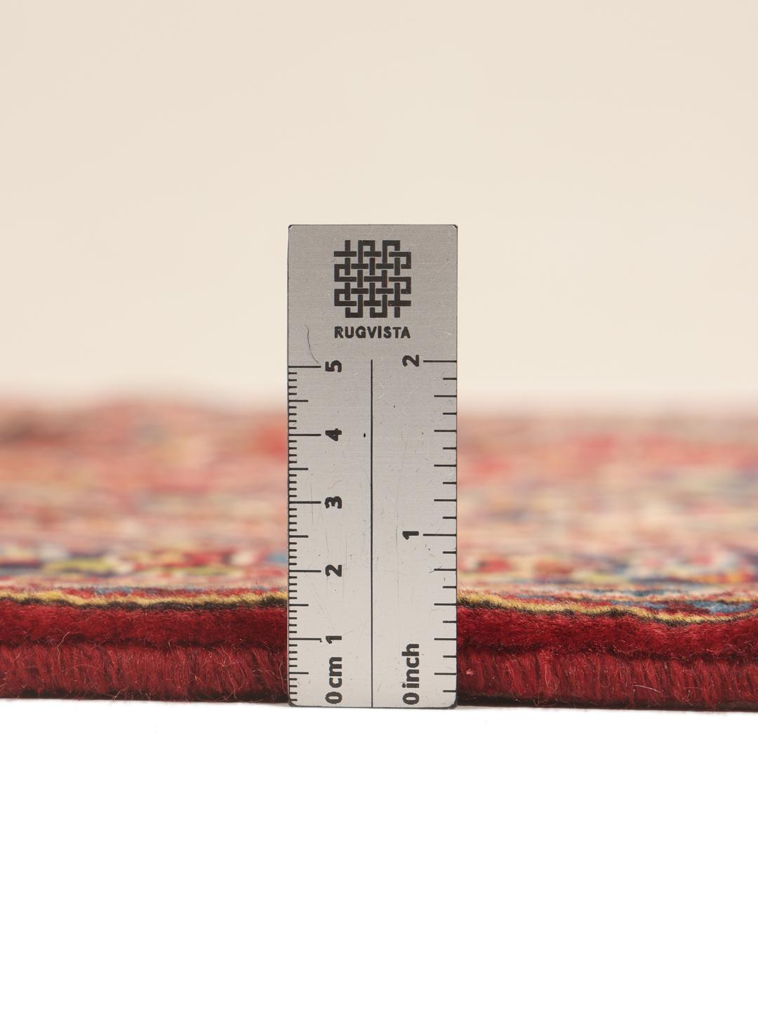 A hand-knotted Keshan rug in red and blue tones from the Middle East.