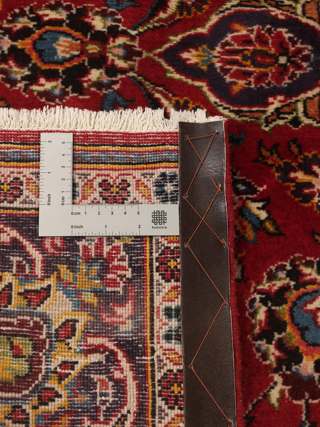 A hand-knotted Keshan rug in red and blue tones from the Middle East.