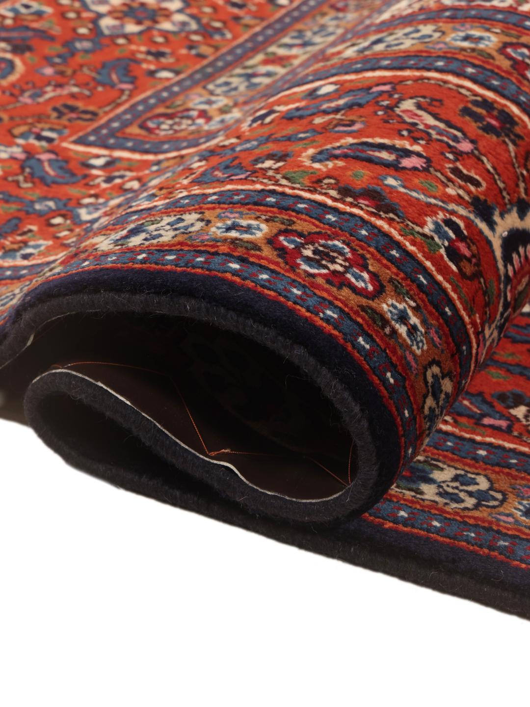 A hand-knotted Moud rug from the Middle East in dark-red and blue tones.