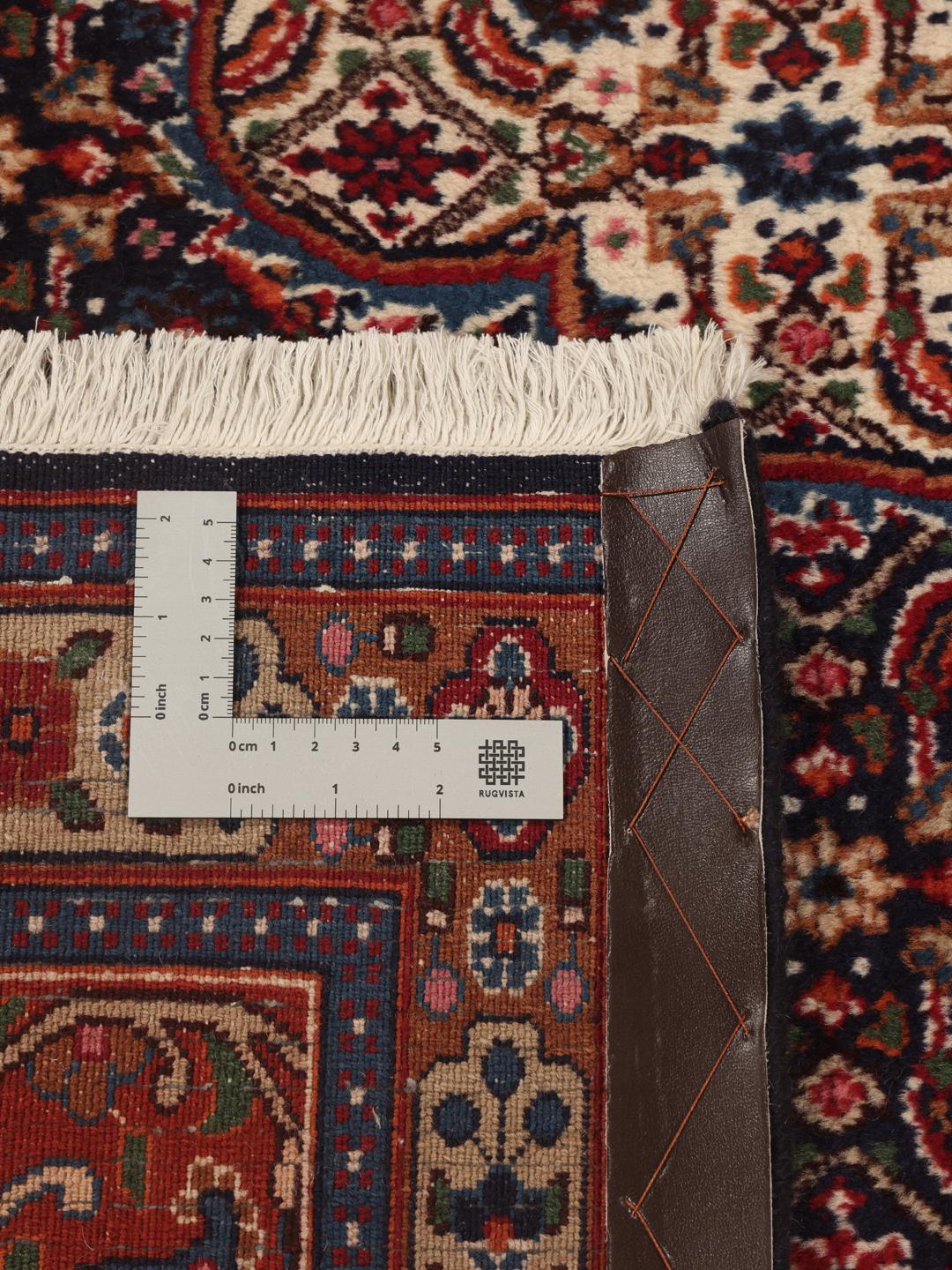 A hand-knotted Moud rug from the Middle East in dark-red and blue tones.