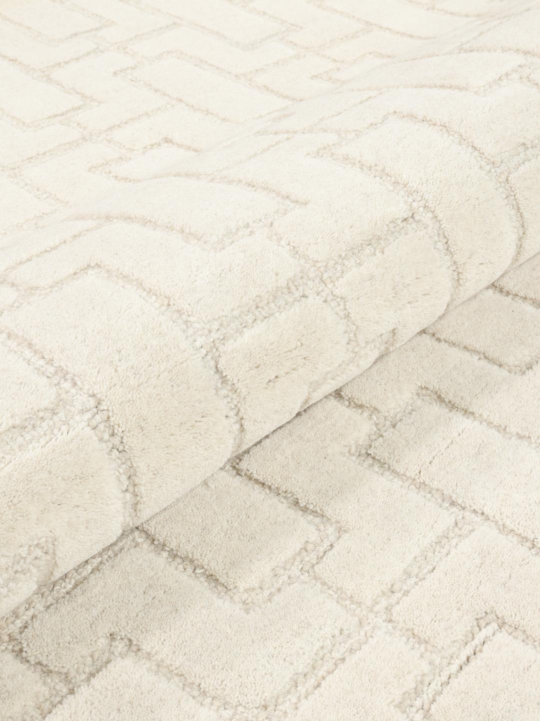 Beige wollen vloerkleed met geometrisch patroon