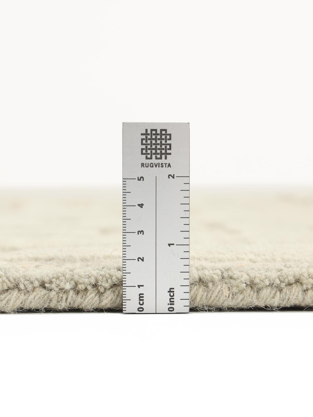 Green rug with a geometric high and low pile texture