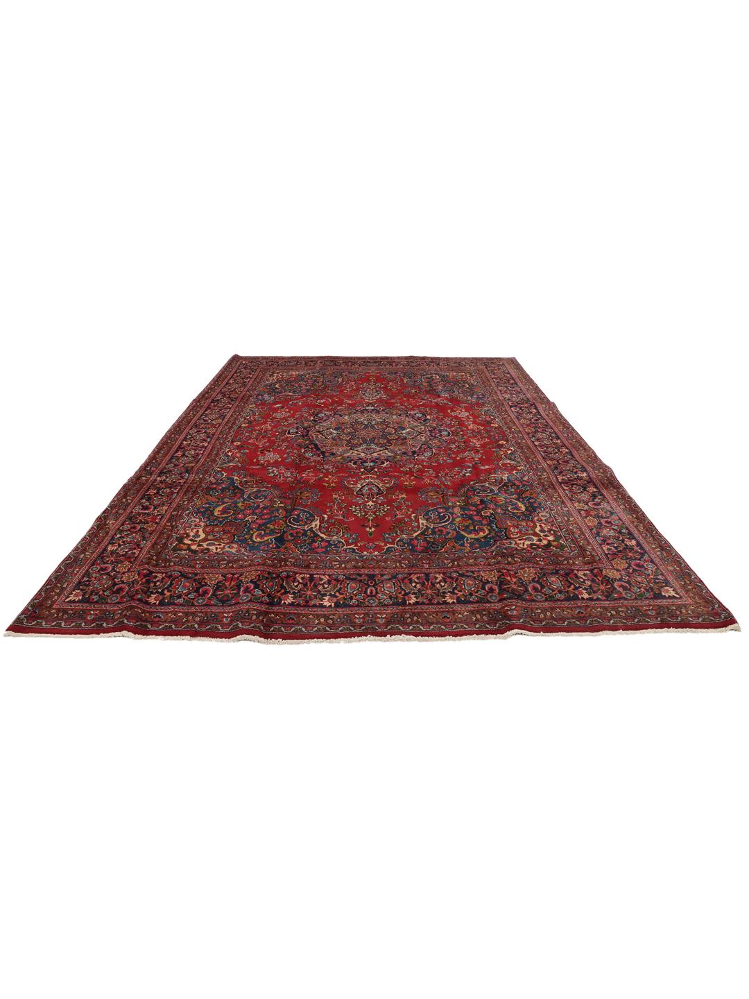 A hand-knotted Mashad rug from the Middle East in shades of red and blue.
