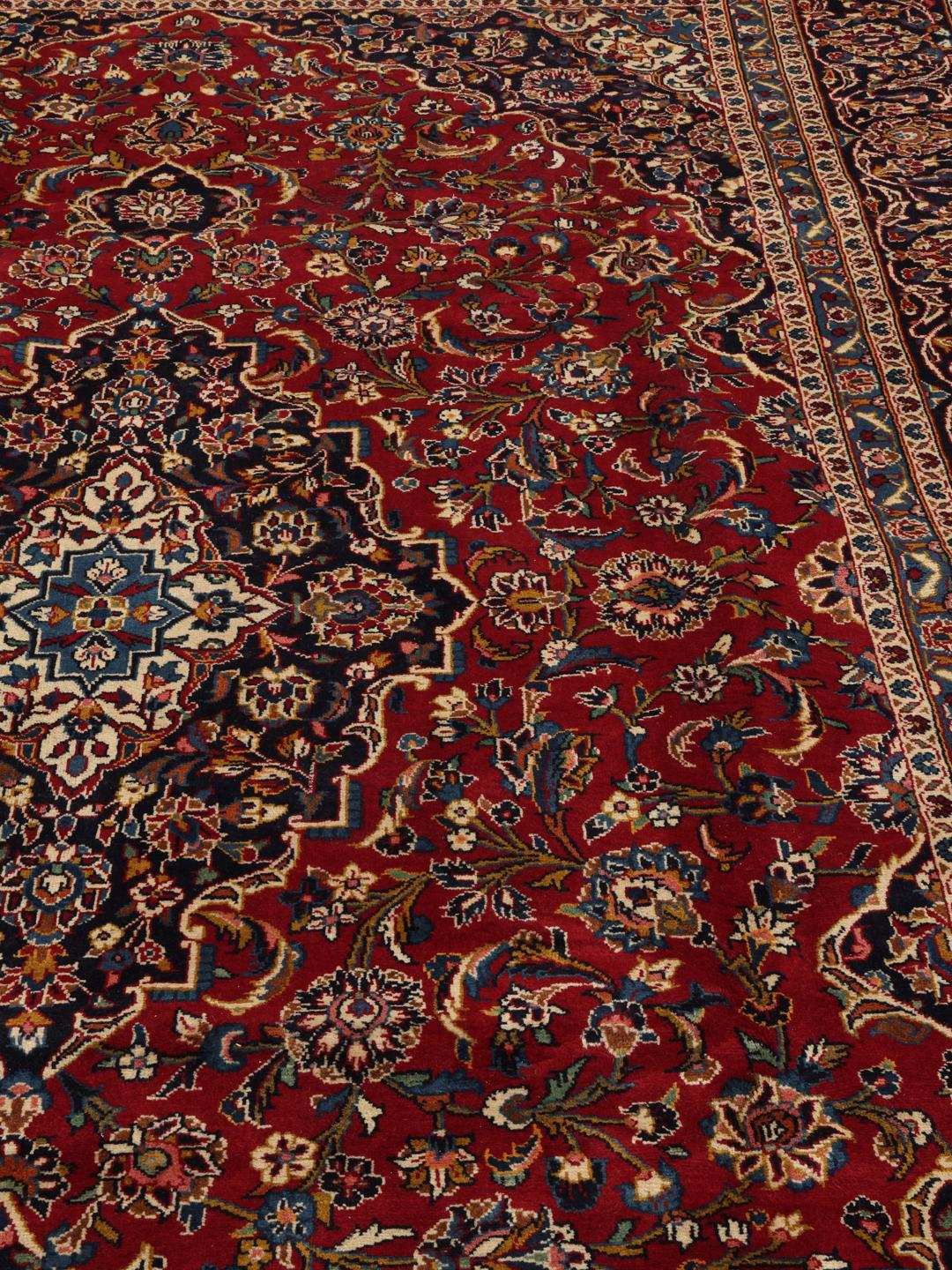A hand-knotted Keshan rug from the Middle East in deep red and blue tones