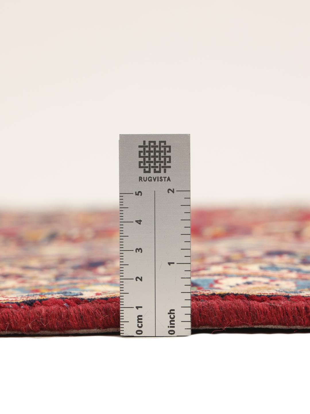 A hand-knotted Keshan rug from the Middle East in deep red and blue tones