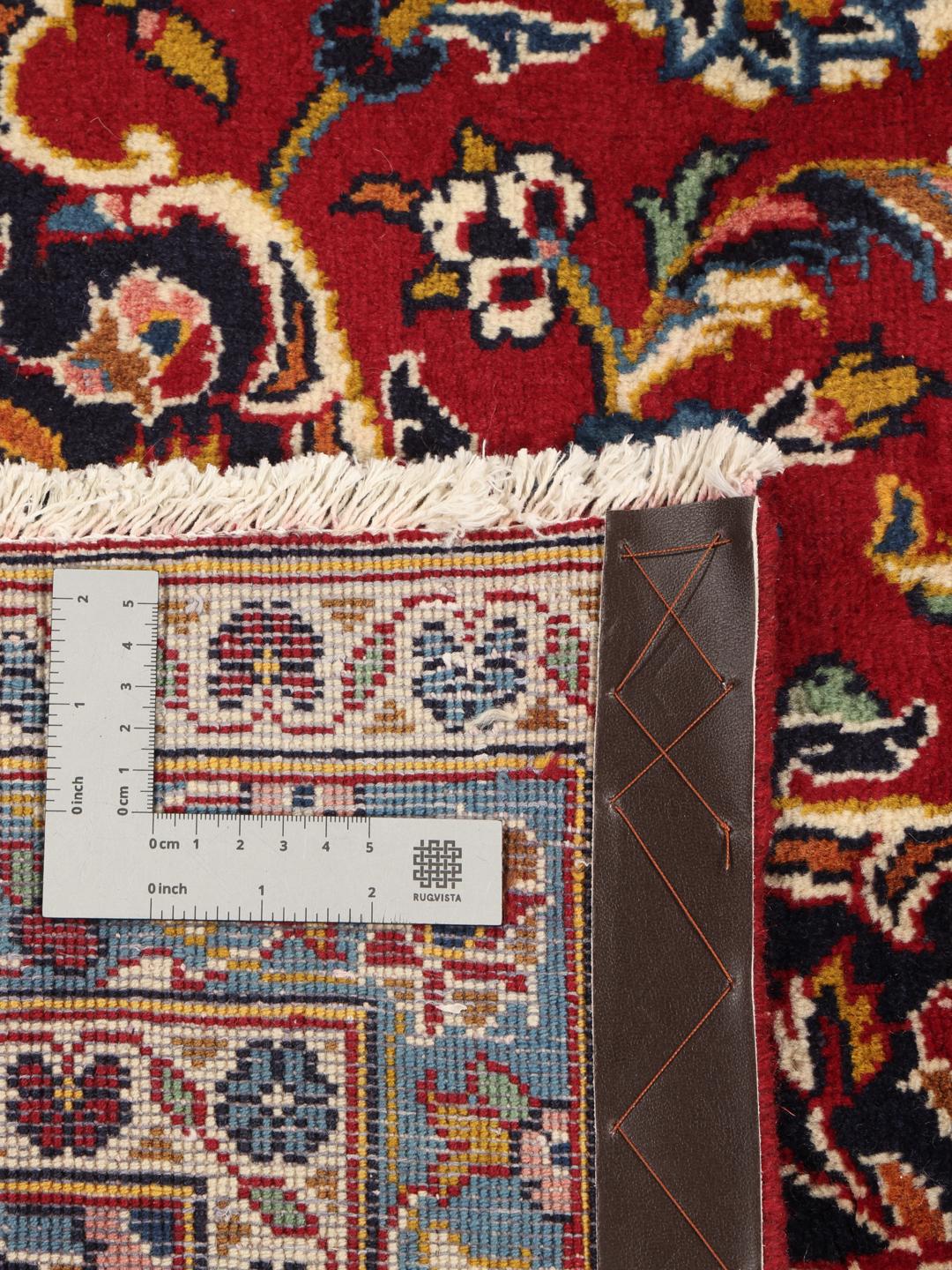 A hand-knotted Keshan rug from the Middle East in deep red and blue tones