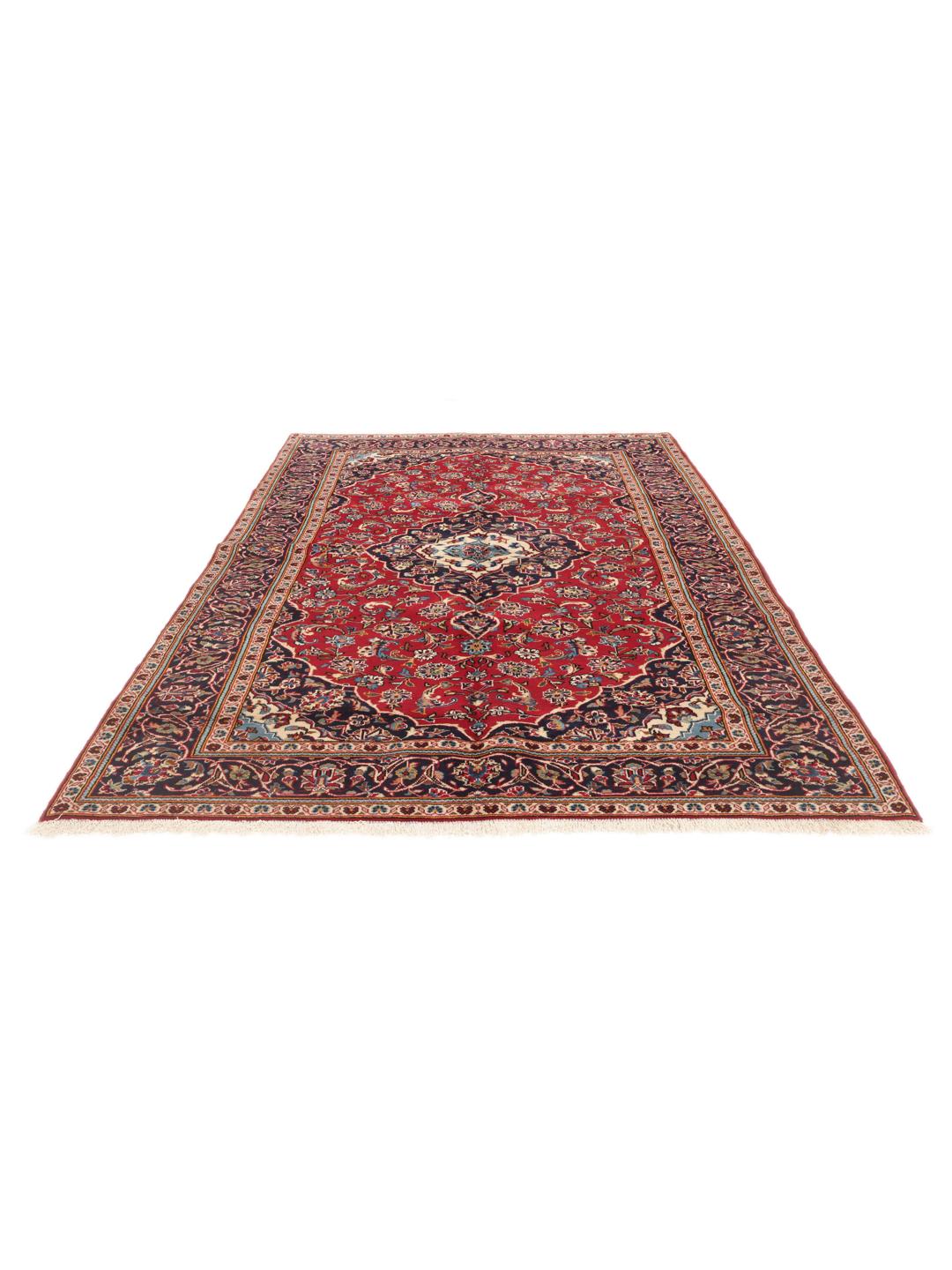 A hand-knotted Middle Eastern Keshan rug with a red and blue floral medallion design.