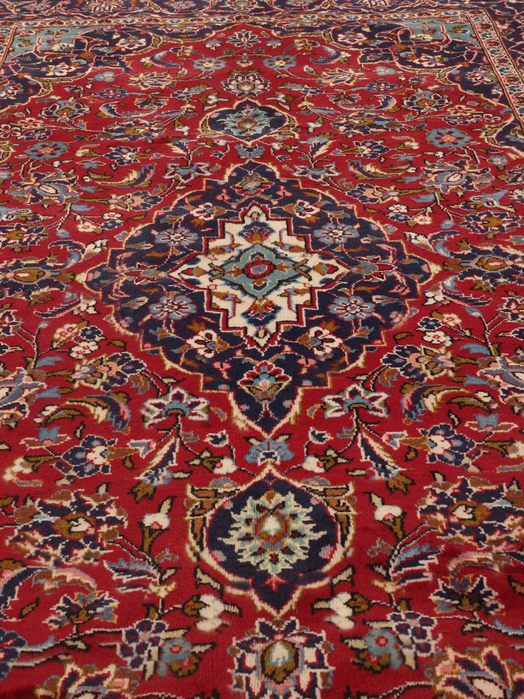 Hand-knotted Keshan rug from the Middle East in red and dark blue