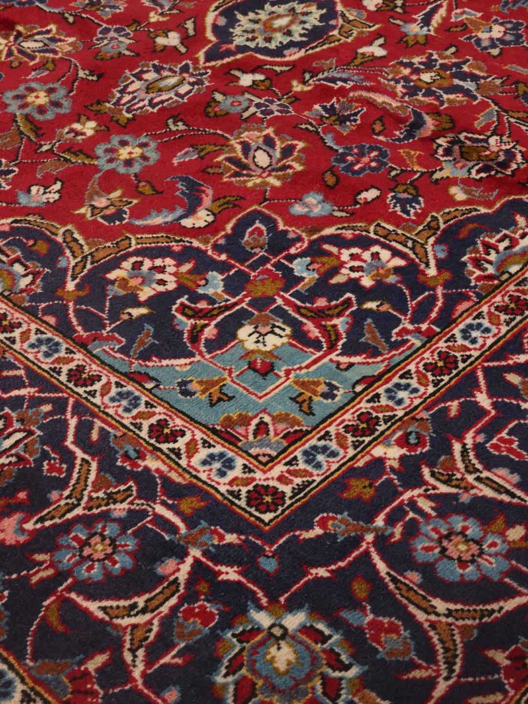Hand-knotted Keshan rug from the Middle East in red and dark blue