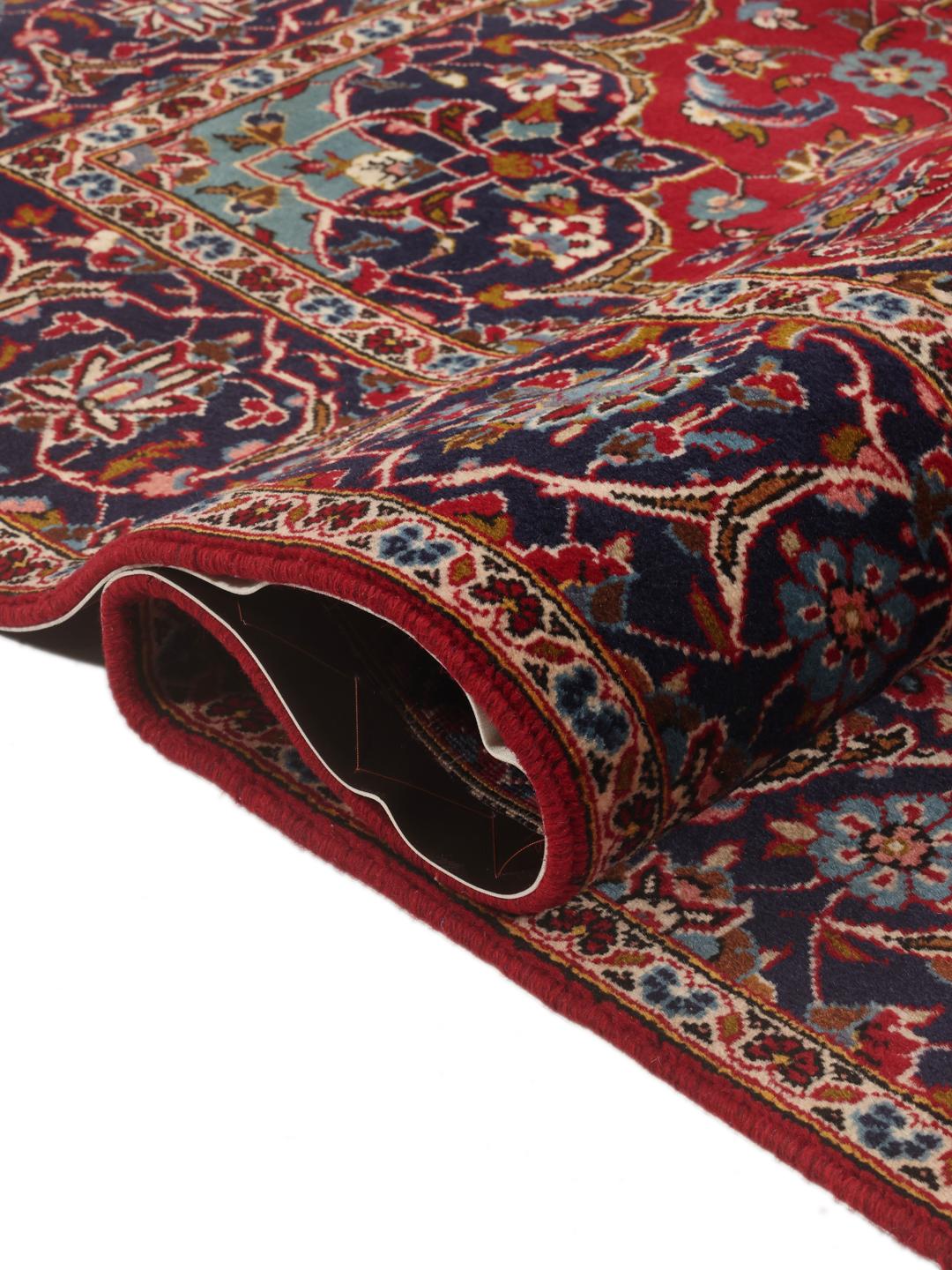 Hand-knotted Keshan rug from the Middle East in red and dark blue