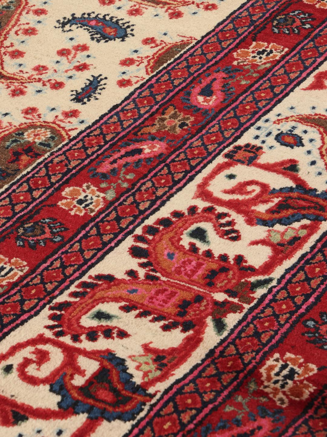 Hand-knotted Moud rug from the Middle East featuring a red and beige floral pattern