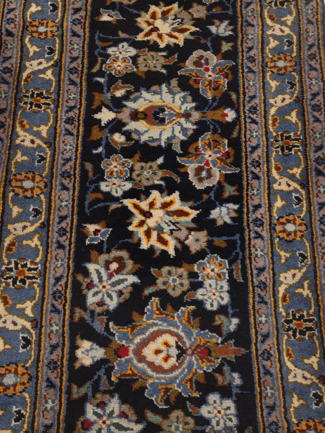 A large, hand-knotted Keshan rug from the Middle East in dark-blue with a central medallion.