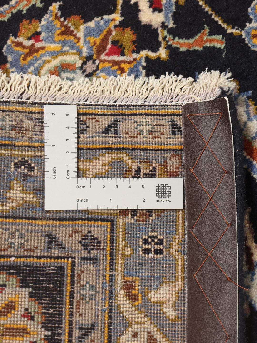 A large, hand-knotted Keshan rug from the Middle East in dark-blue with a central medallion.