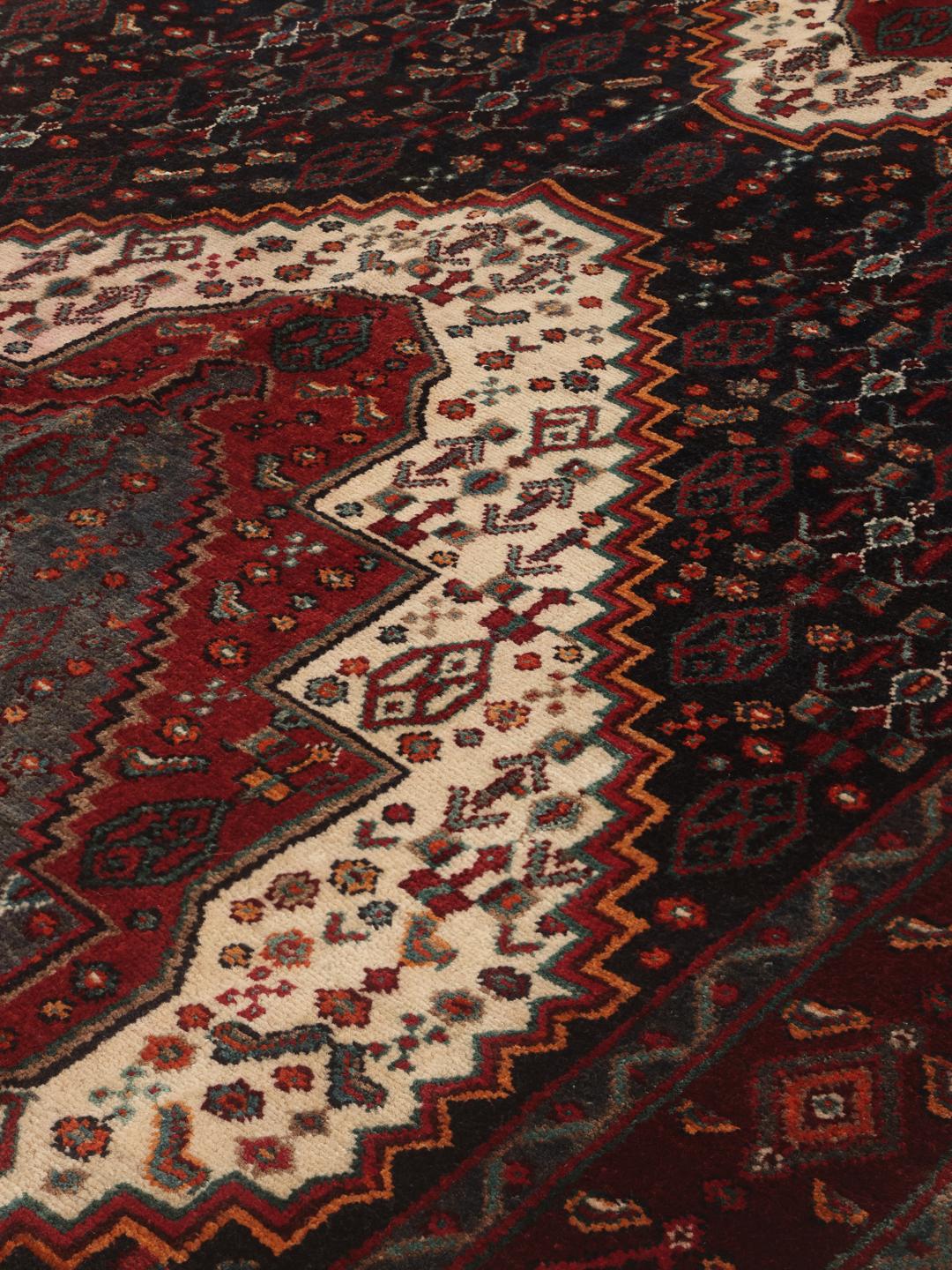 Hand-knotted Senneh runner with a dark multicolor medallion pattern