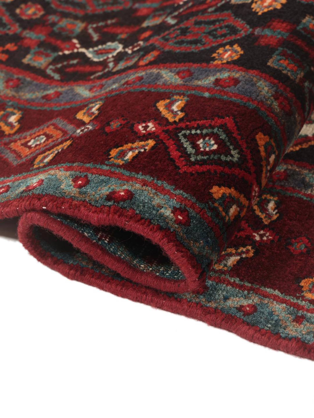 Hand-knotted Senneh runner with a dark multicolor medallion pattern