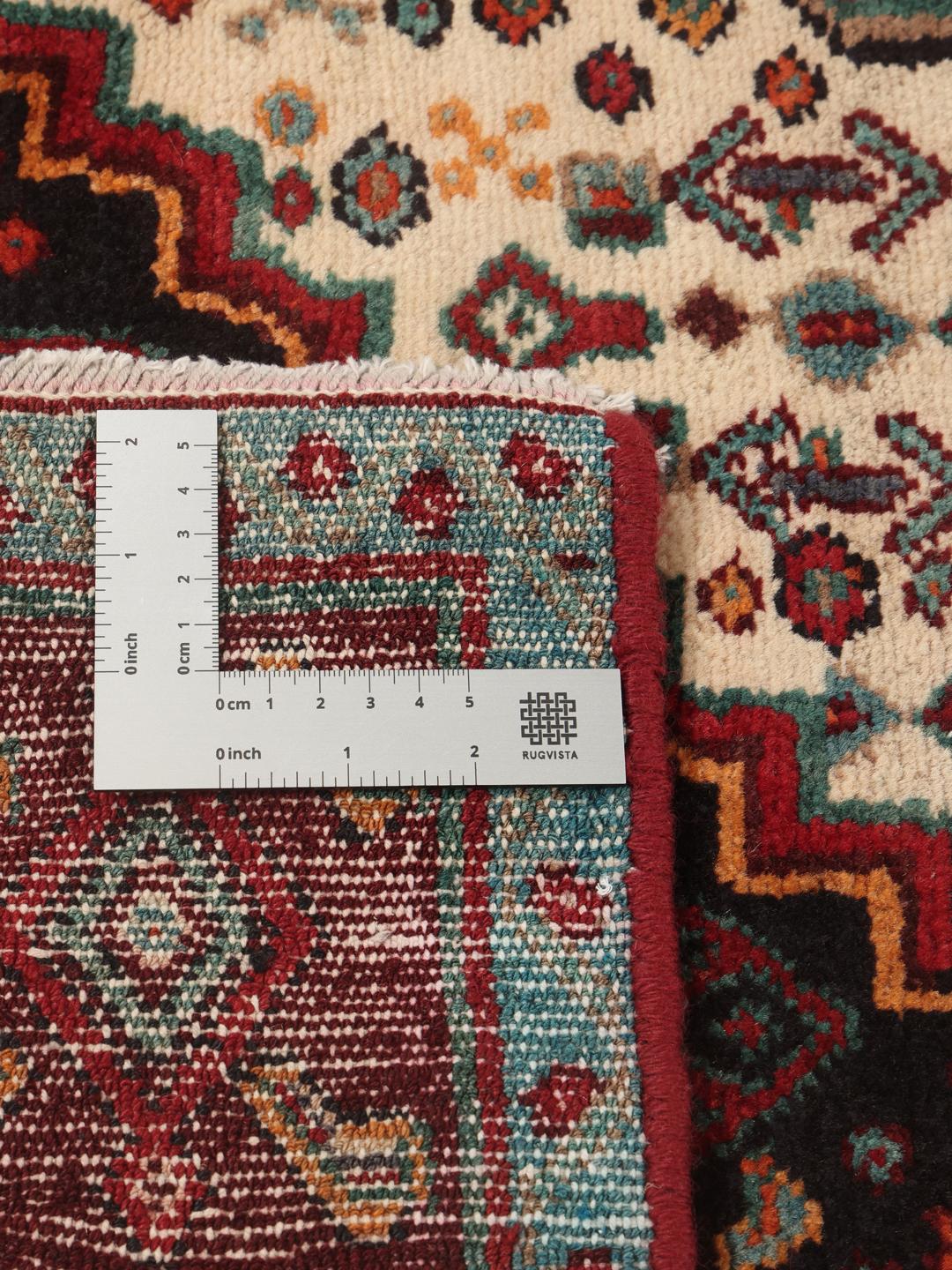 Hand-knotted Senneh runner with a dark multicolor medallion pattern