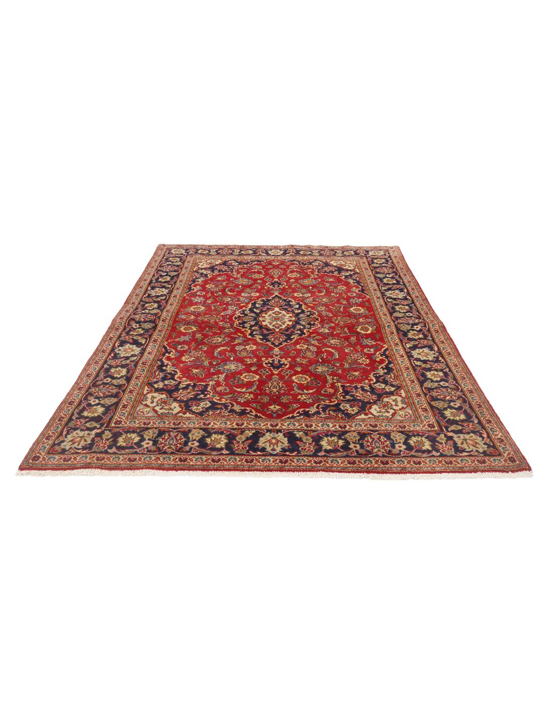 A hand-knotted Middle Eastern Keshan rug with a vibrant red and deep blue floral pattern.