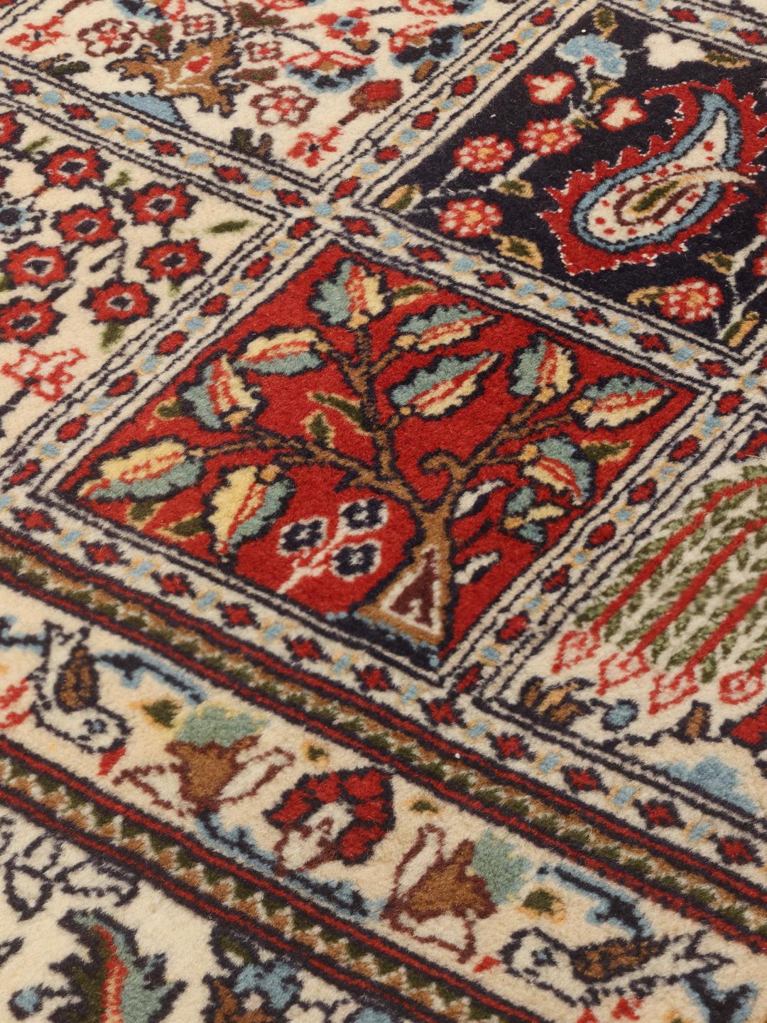 Hand knotted Moud rug from the Middle East featuring a multicolor grid pattern with floral motifs