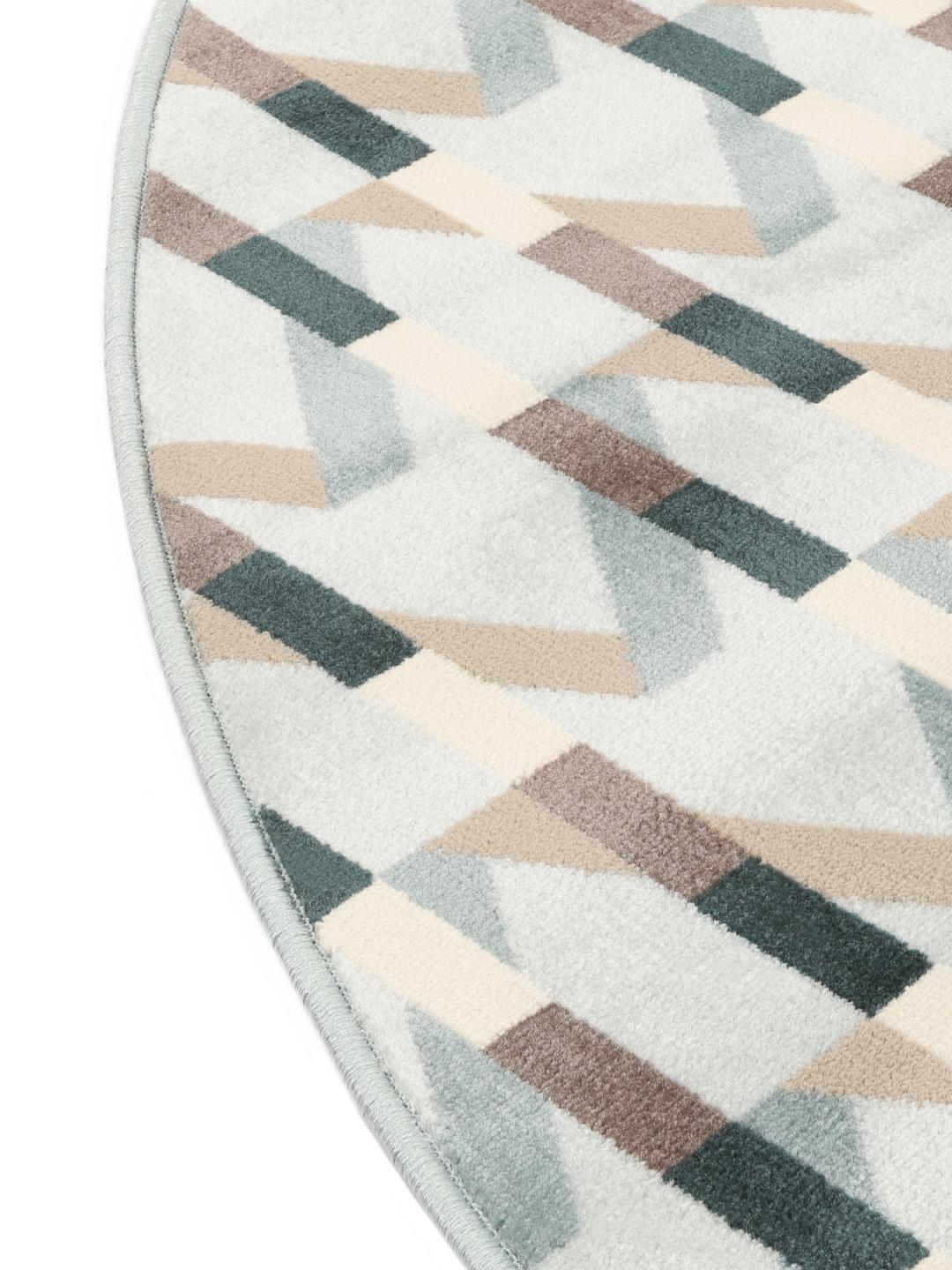 Tapis rond bleu clair avec un motif géométrique rythmé