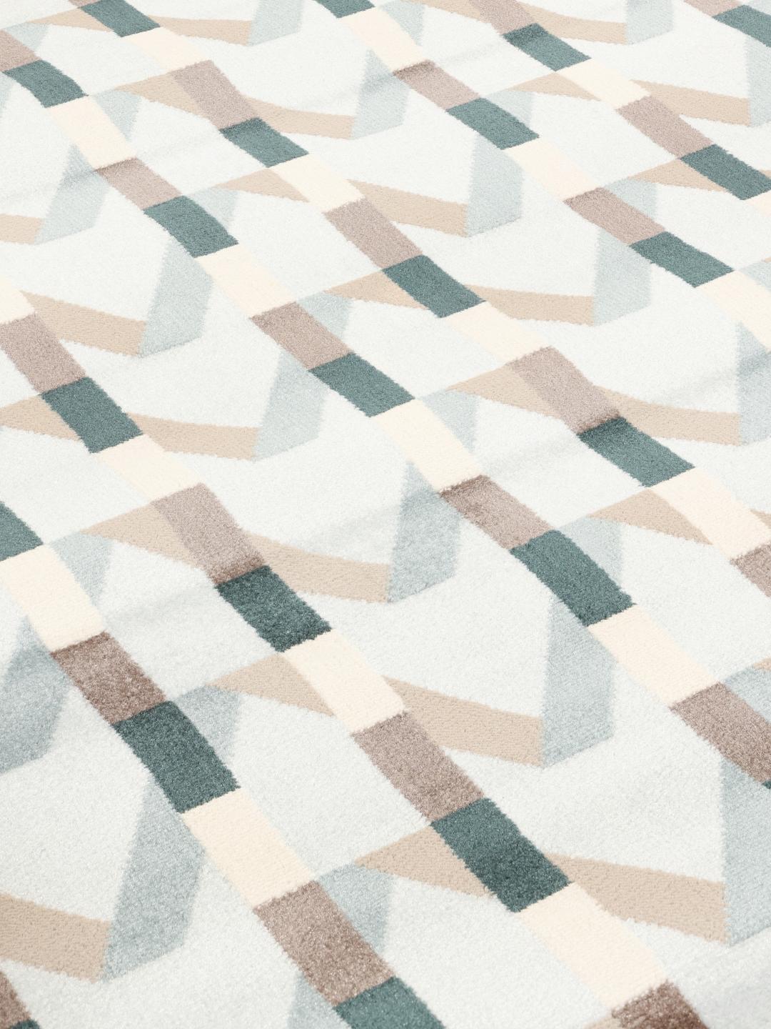 Tapis rond bleu clair avec un motif géométrique rythmé