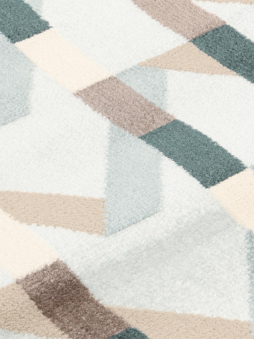 Tapis rond bleu clair avec un motif géométrique rythmé
