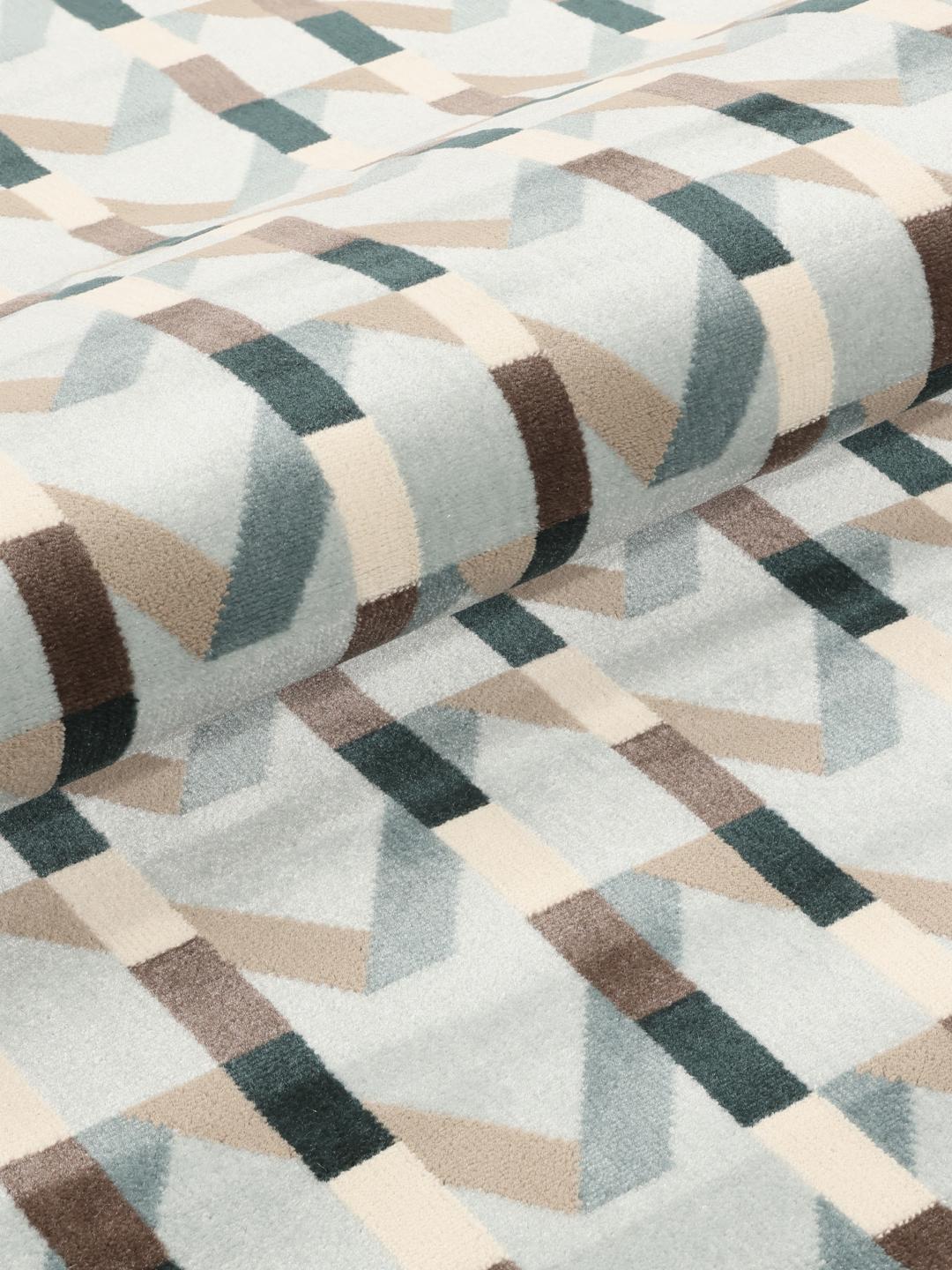 Tapis rond bleu clair avec un motif géométrique rythmé