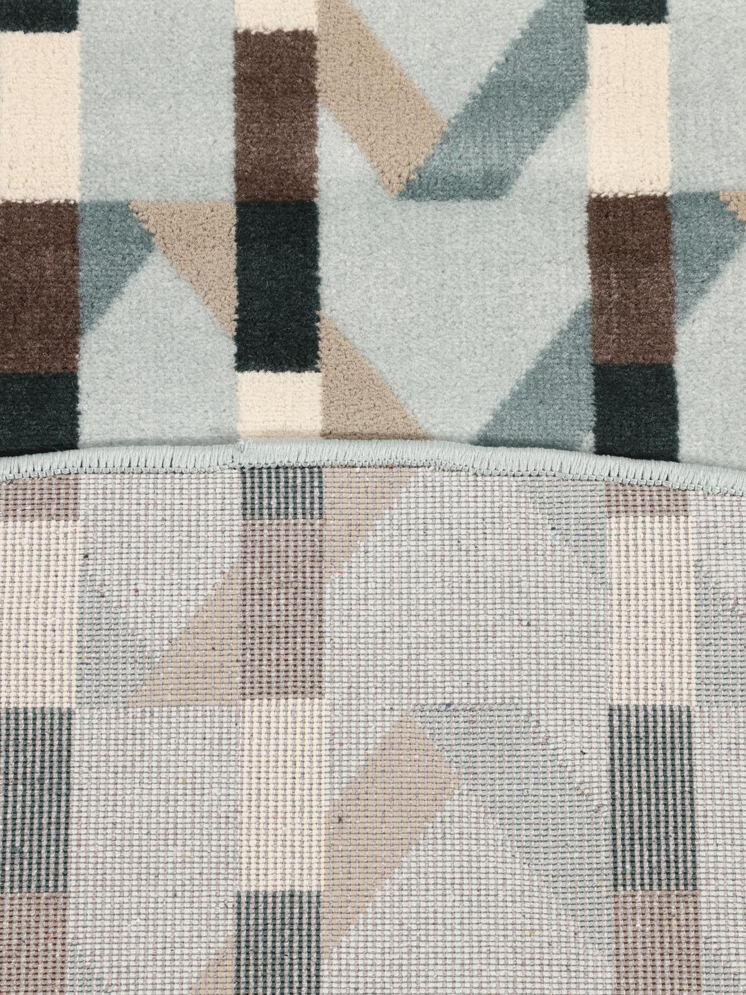 Tapis rond bleu clair avec un motif géométrique rythmé