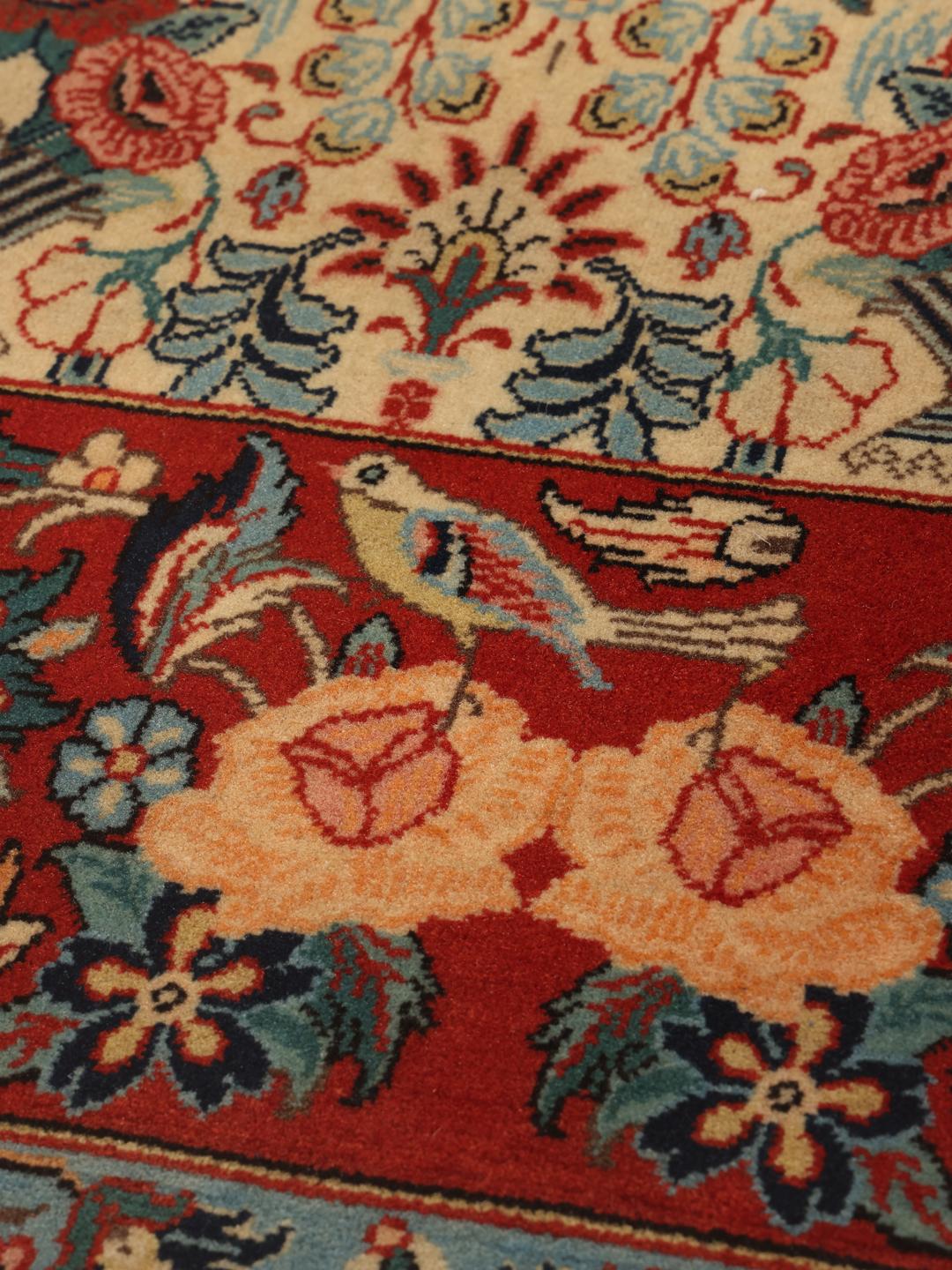 Hand-knotted Varamin rug with intricate floral patterns in red and beige from the Middle East
