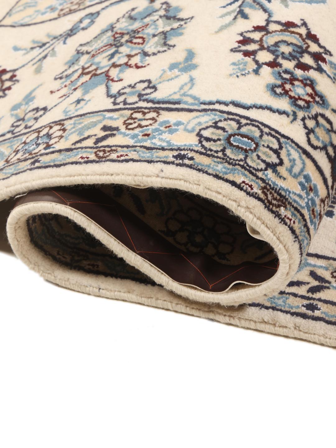 Hand-knotted Middle Eastern Nain rug featuring a dark-blue field with intricate floral patterns.