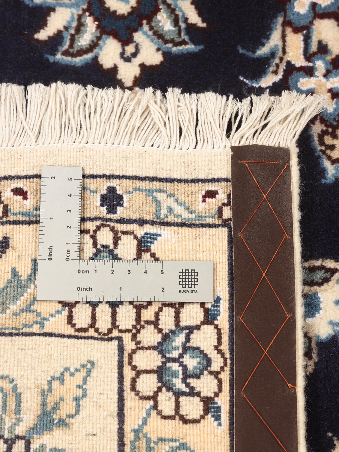 Hand-knotted Middle Eastern Nain rug featuring a dark-blue field with intricate floral patterns.