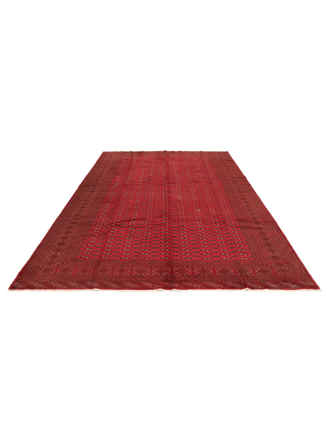 A hand-knotted Turkaman rug from the Middle East in deep red featuring geometric patterns