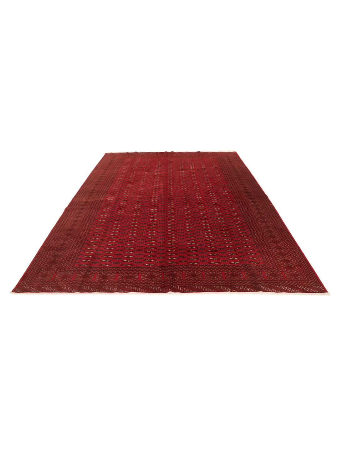 A hand-knotted Turkaman rug from the Middle East in deep red featuring geometric patterns
