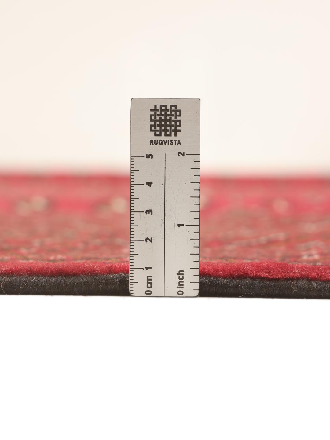 A hand-knotted Turkaman rug from the Middle East in deep red featuring geometric patterns