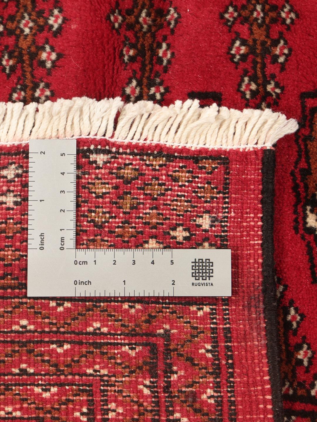 A hand-knotted Turkaman rug from the Middle East in deep red featuring geometric patterns