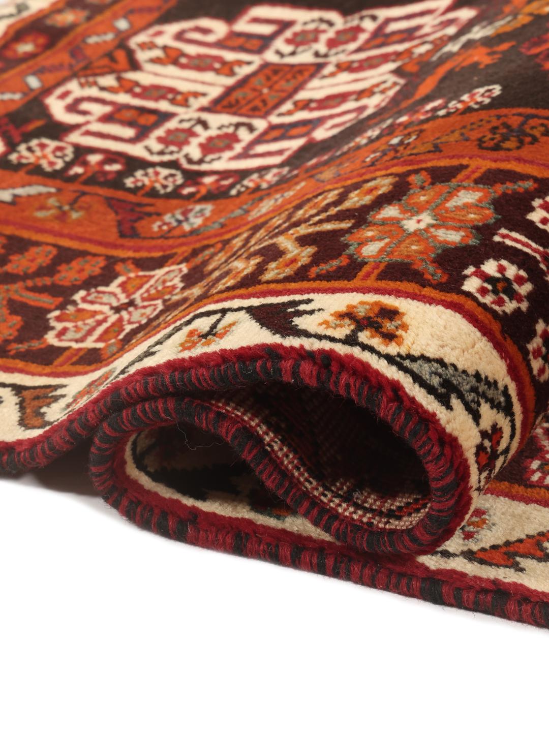 Hand-knotted Qashqai rug with traditional tribal patterns in red and dark tones