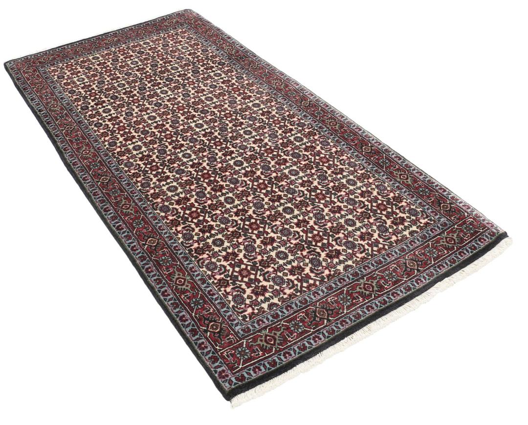 Een handgeknoopt Bidjar-tapijt uit het Midden-Oosten met een donkerrood en beige bloemenpatroon.