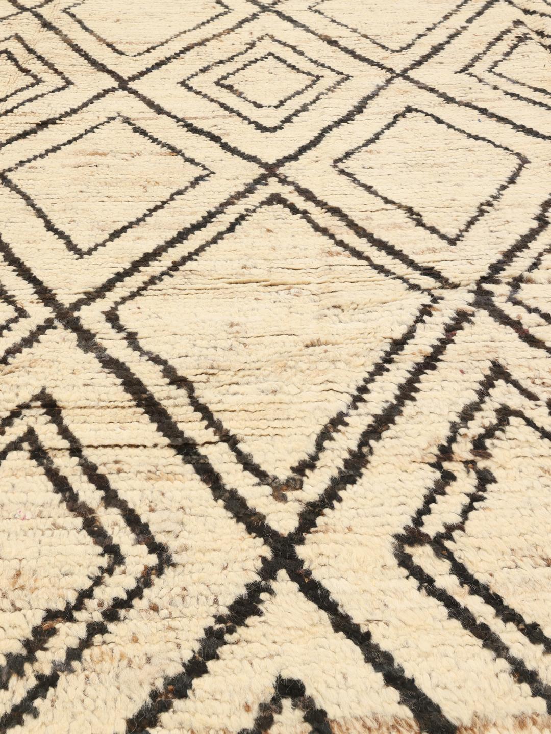 Hand-knotted Afghan rug featuring a geometric diamond pattern in beige and black