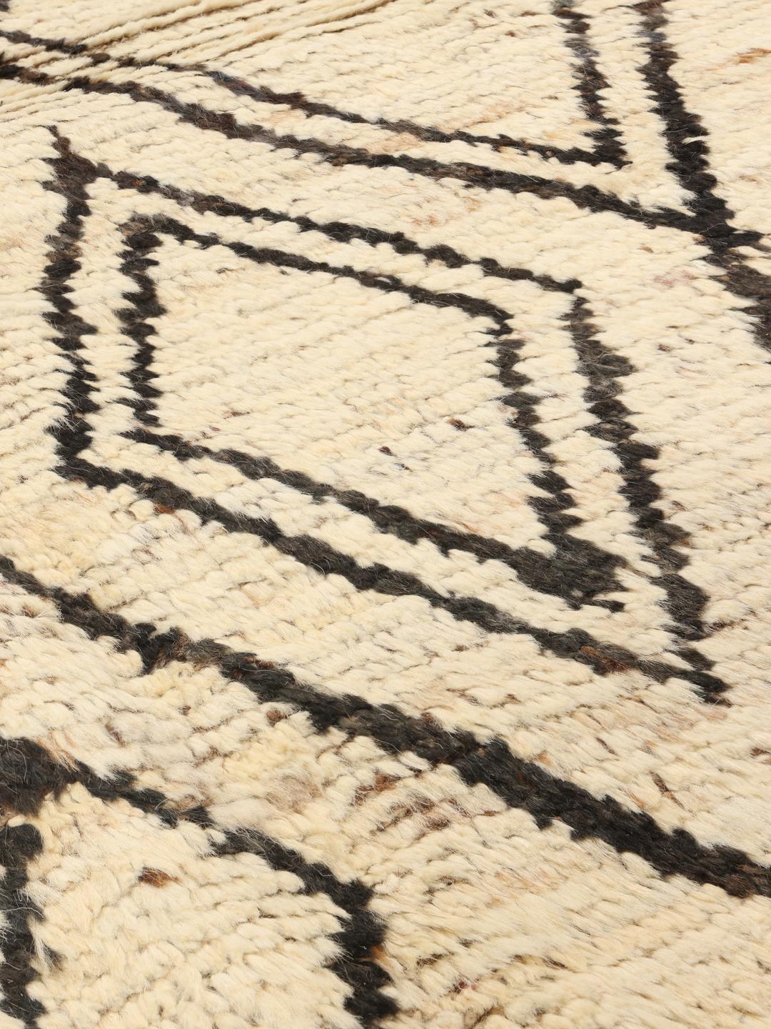 Hand-knotted Afghan rug featuring a geometric diamond pattern in beige and black