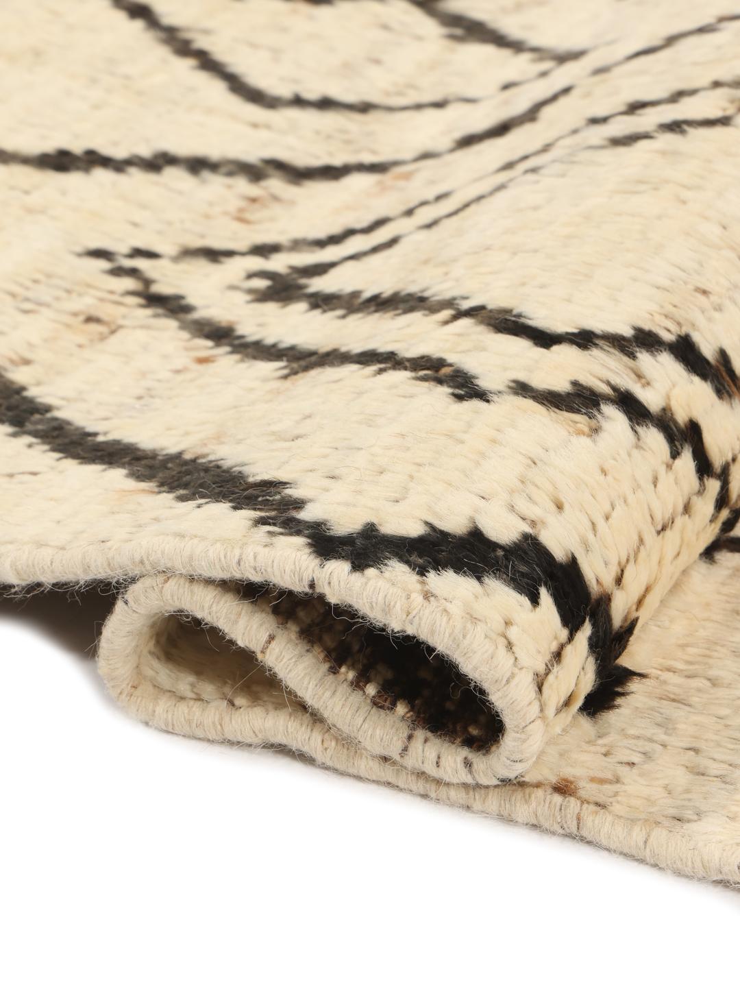 Hand-knotted Afghan rug featuring a geometric diamond pattern in beige and black