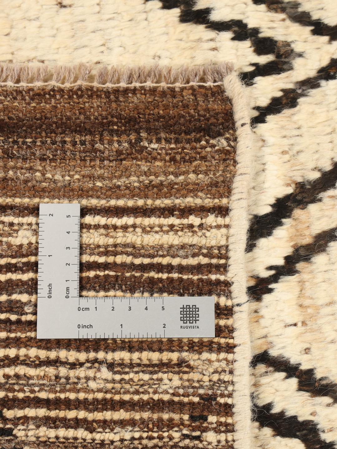 Hand-knotted Afghan rug featuring a geometric diamond pattern in beige and black