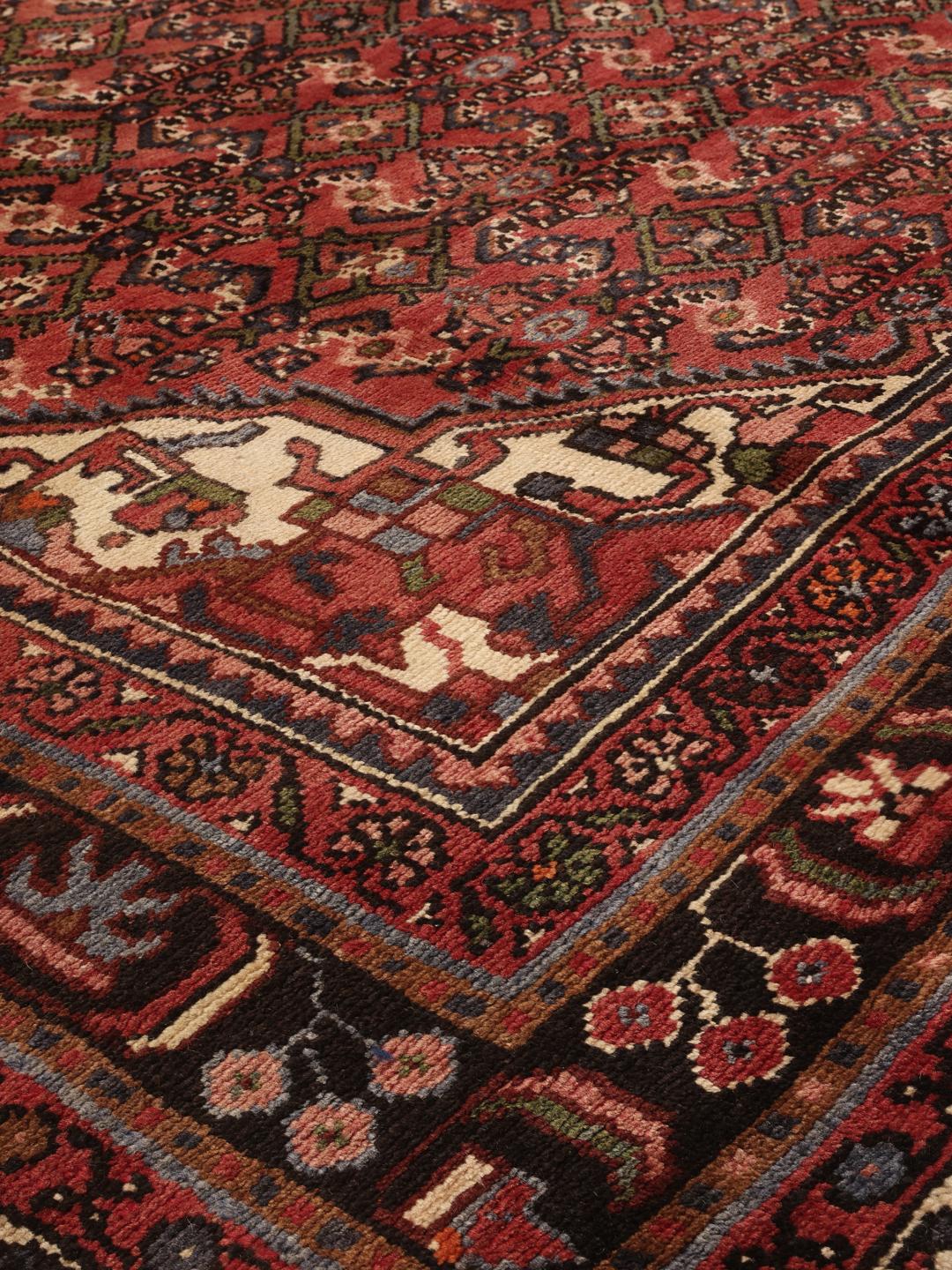 Hand-knotted Hosseinabad rug from the Middle East in deep red tones
