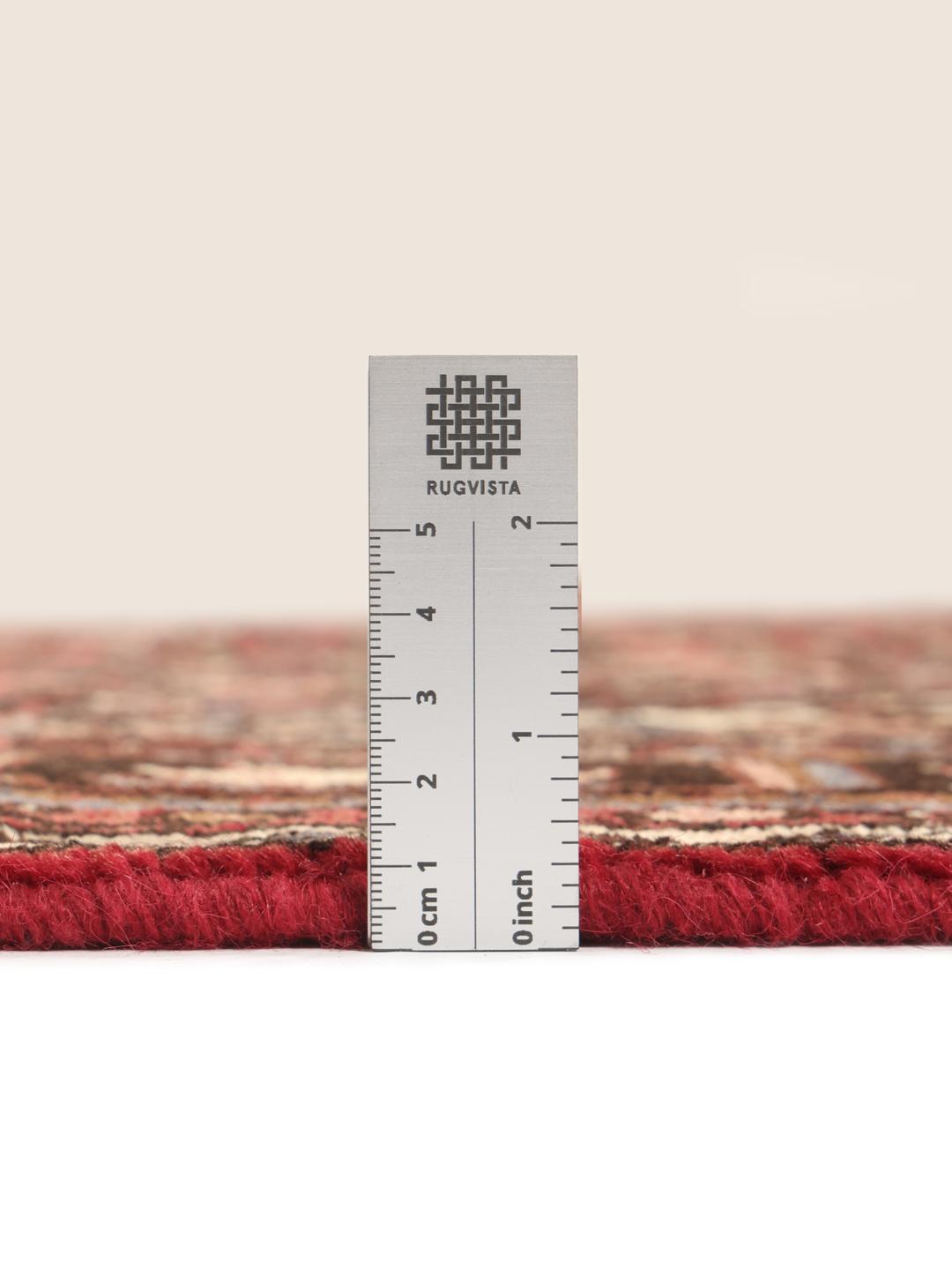 Hand-knotted Hosseinabad rug from the Middle East in deep red tones