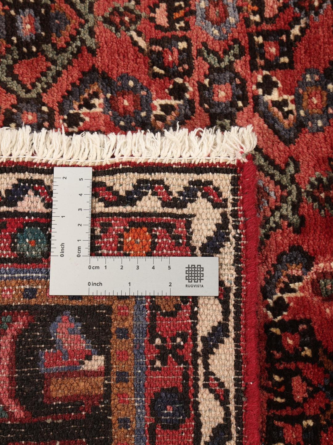 Hand-knotted Hosseinabad rug from the Middle East in deep red tones