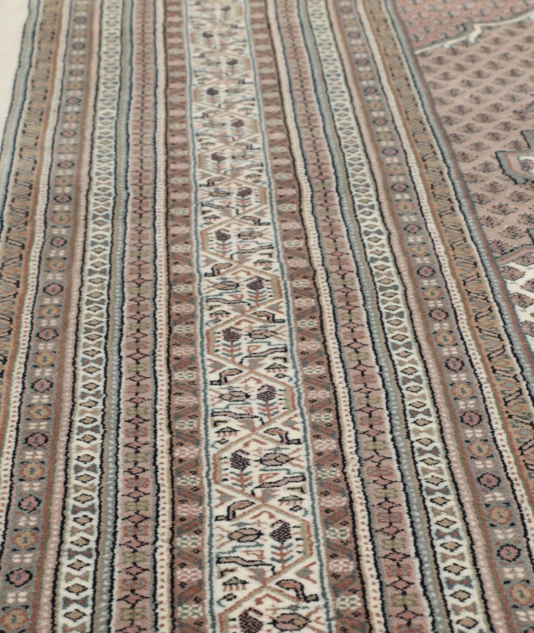 A large rectangular hand-knotted Sarouk Mir rug from India in shades of brown and beige.