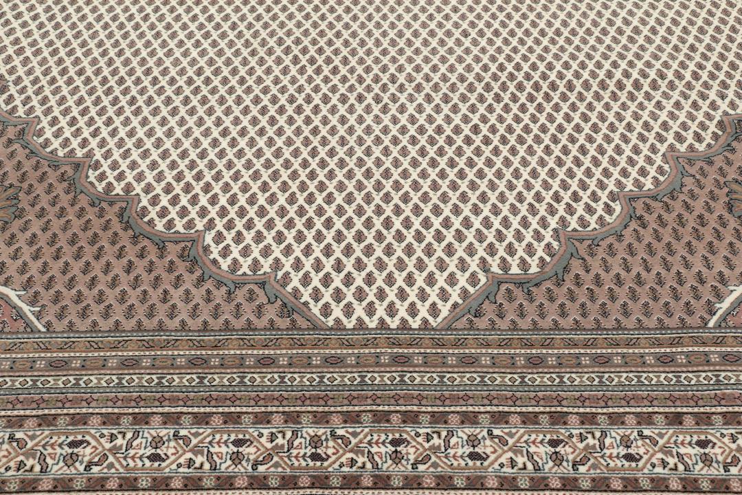 A large rectangular hand-knotted Sarouk Mir rug from India in shades of brown and beige.