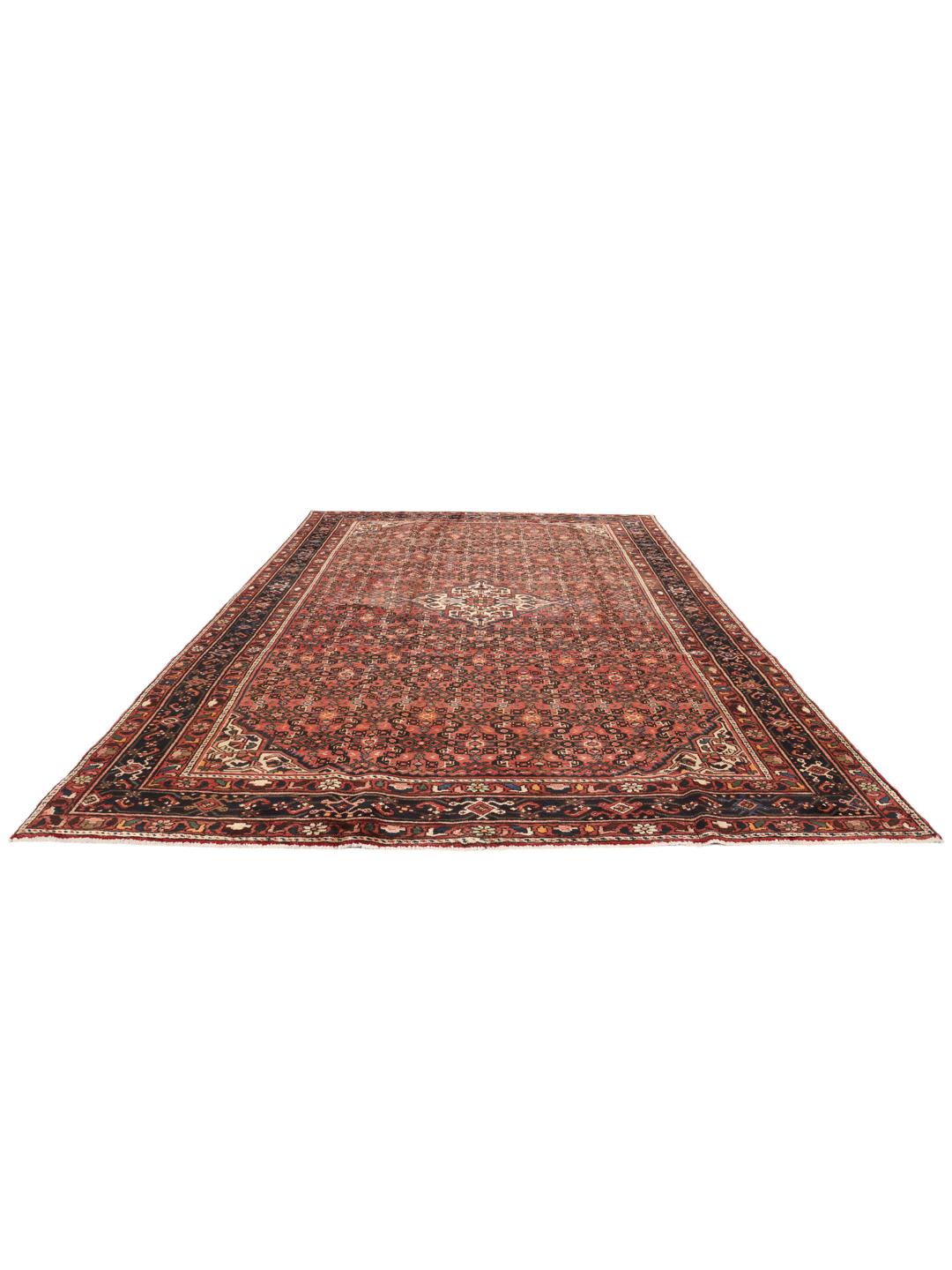A hand-knotted Hosseinabad rug from the Middle East featuring a dark-red field and intricate patterns.